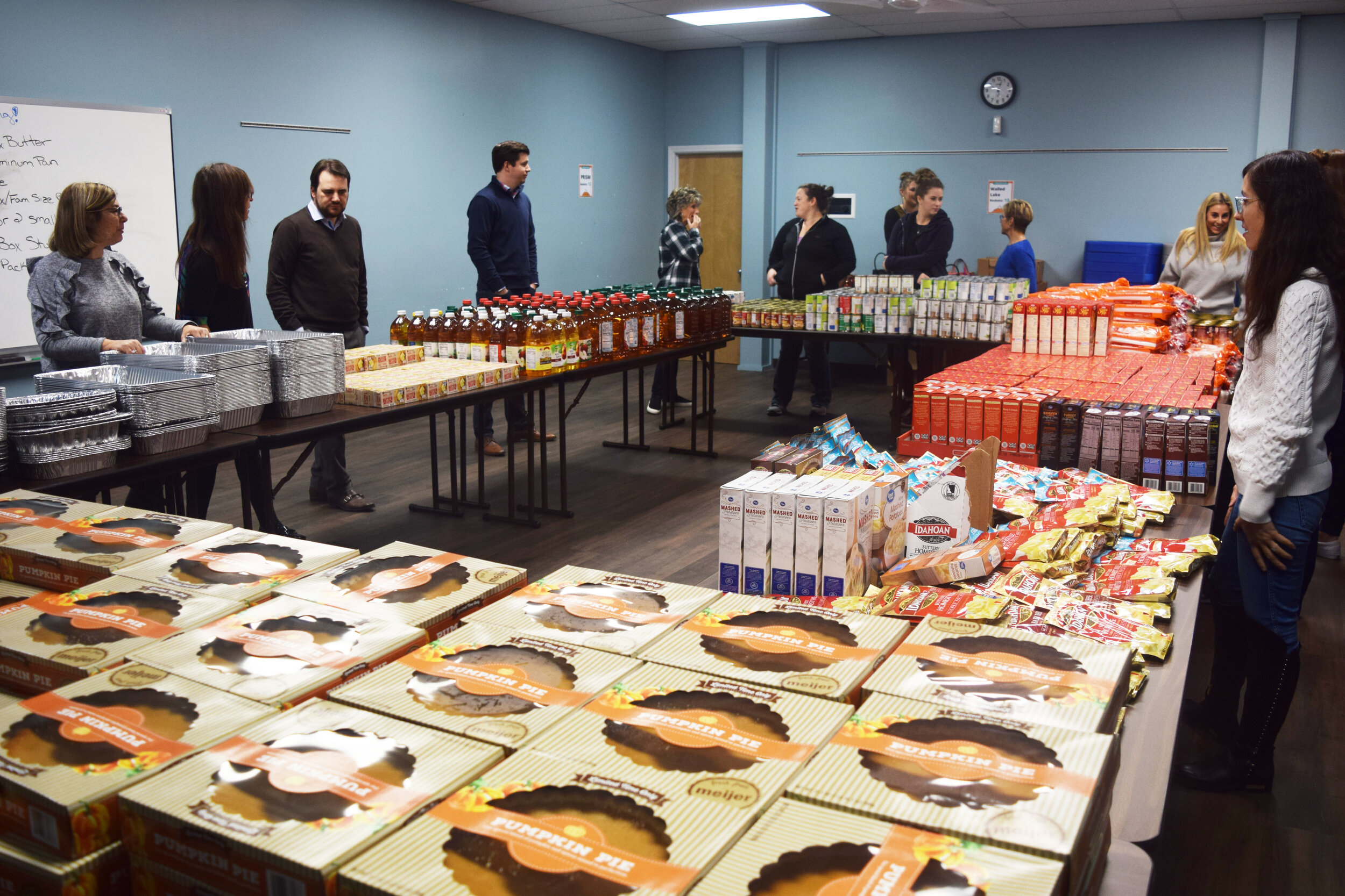 Volunteers get ready to assemble Thanksgiving baskets.