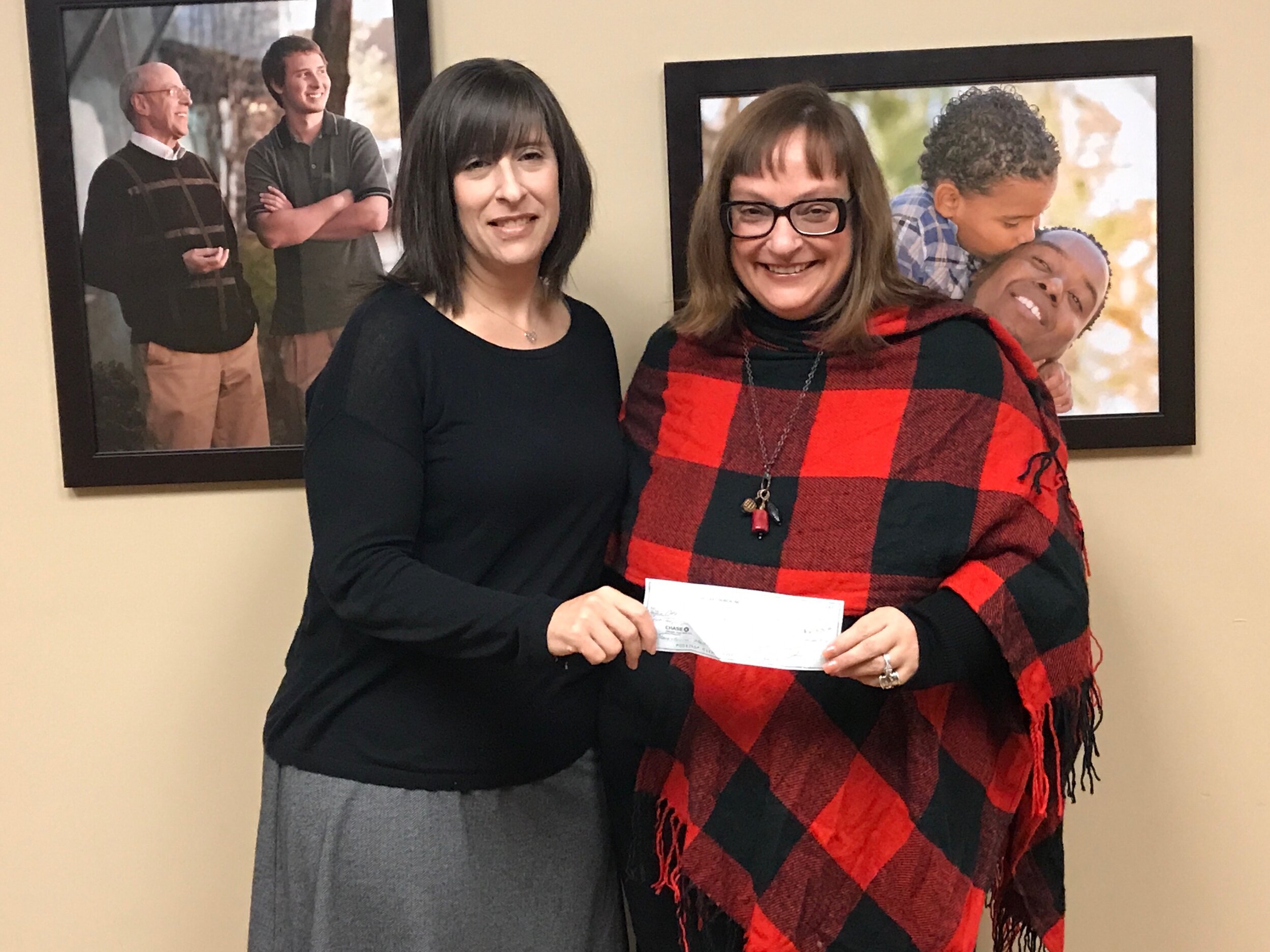 President/CEO Jaimie Clayton receives a donation from Marianne Long, director of Volunteer &amp; Community Outreach at One Oak Church in Royal Oak.