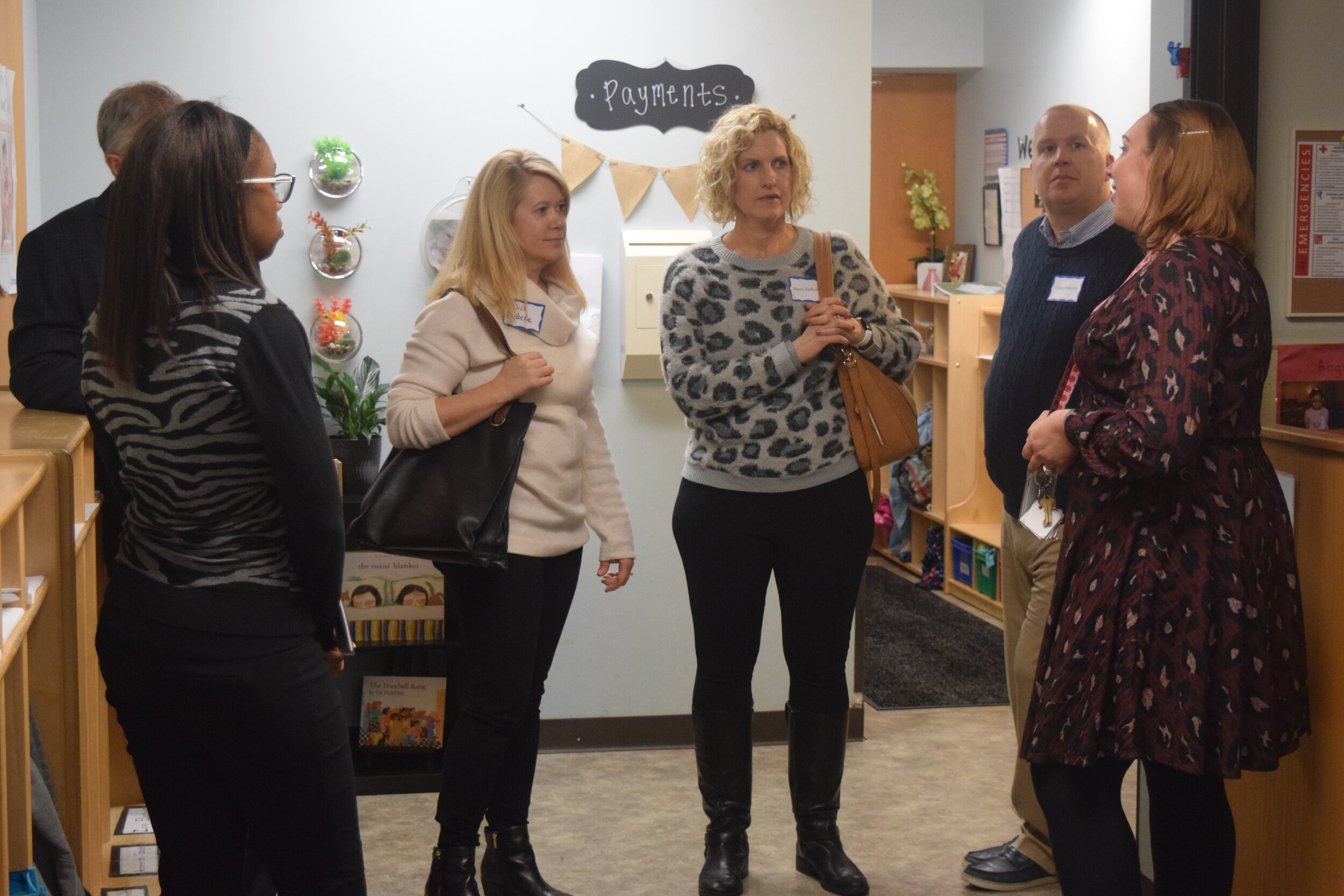 Lead Preschool Teacher Gail Petrusha (far right) gives guests a tour of the Children's Learning Center.