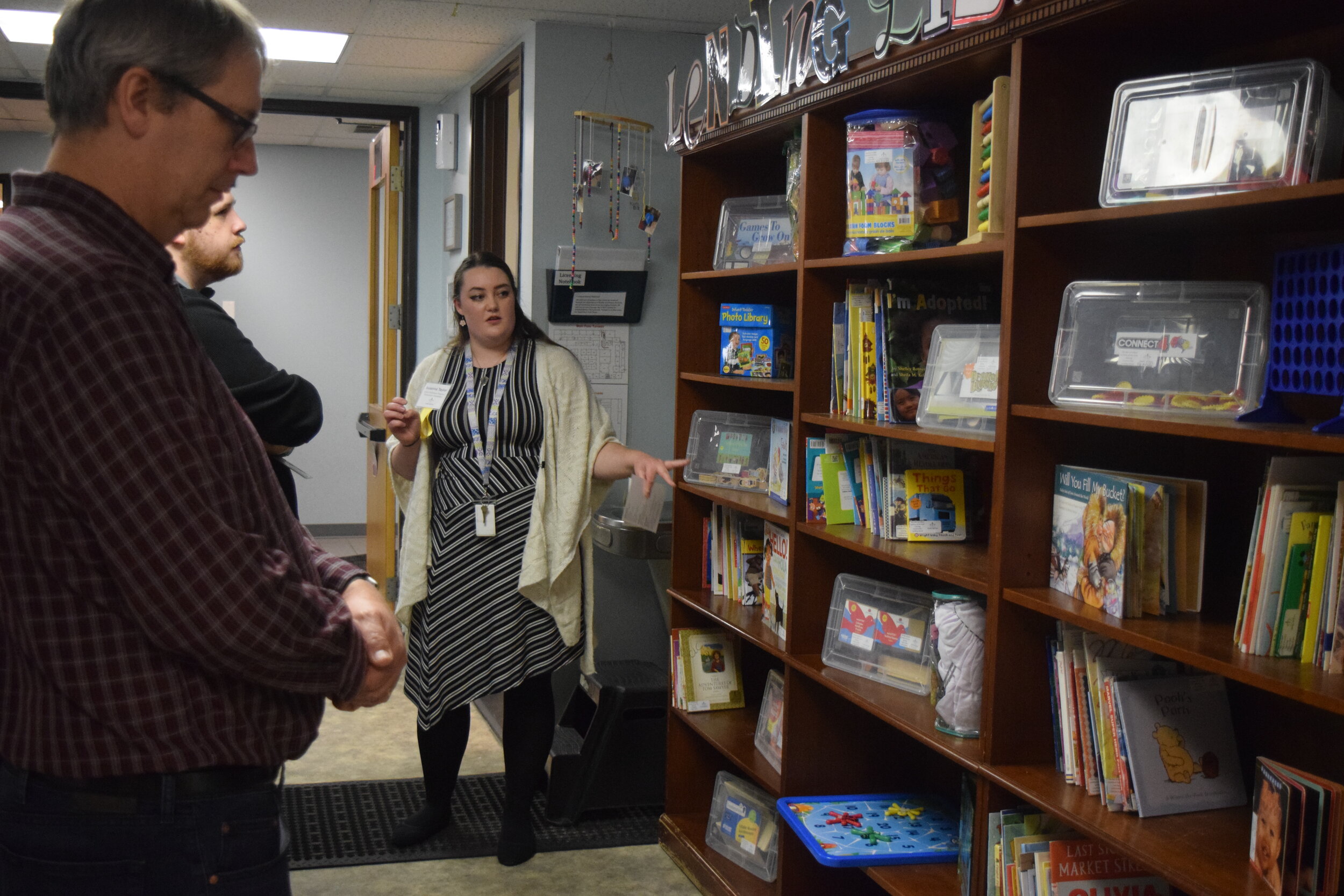 Susanna Taylor shows guests the Lending Library.
