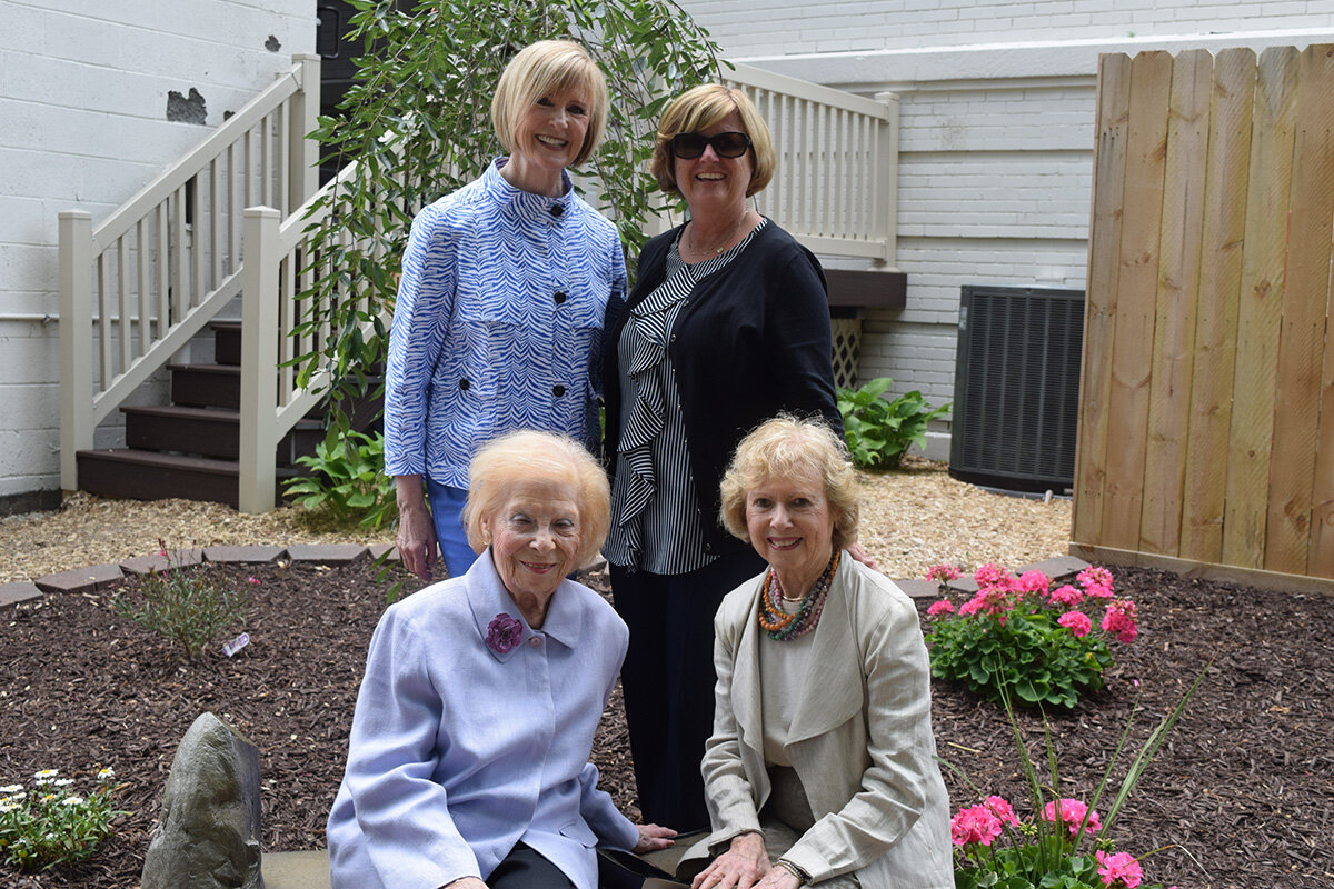  Lassie Lewis (back left) and Michele Becker (back right) are pictured with two other attendees of the 2017 dedication of the Brigitte P. Harris Memorial Playground and Garden at Oakland Family Services’ Pontiac location. 