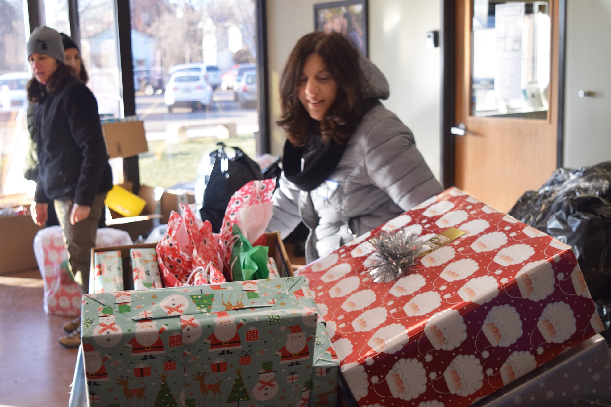  Volunteers organize Adopt A Family gifts in 2019, the last year that Oakland Family Services was able to collect physical gifts. This year marks an exciting return to Adopt A Family tradition! 