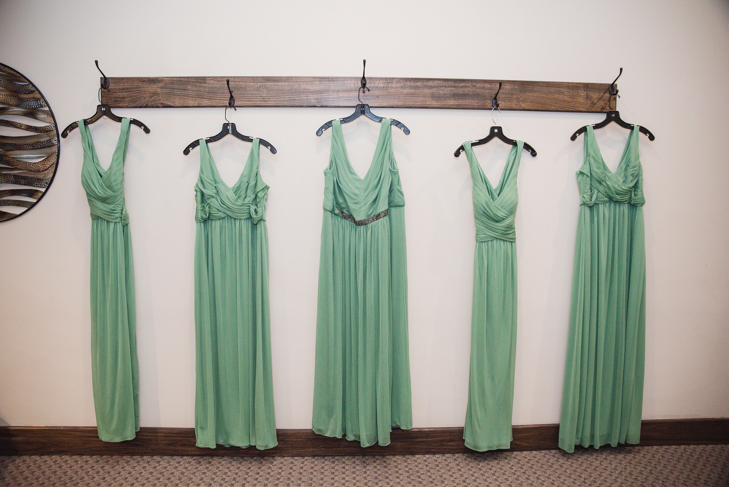 bridesmaid dresses hanging on the wall