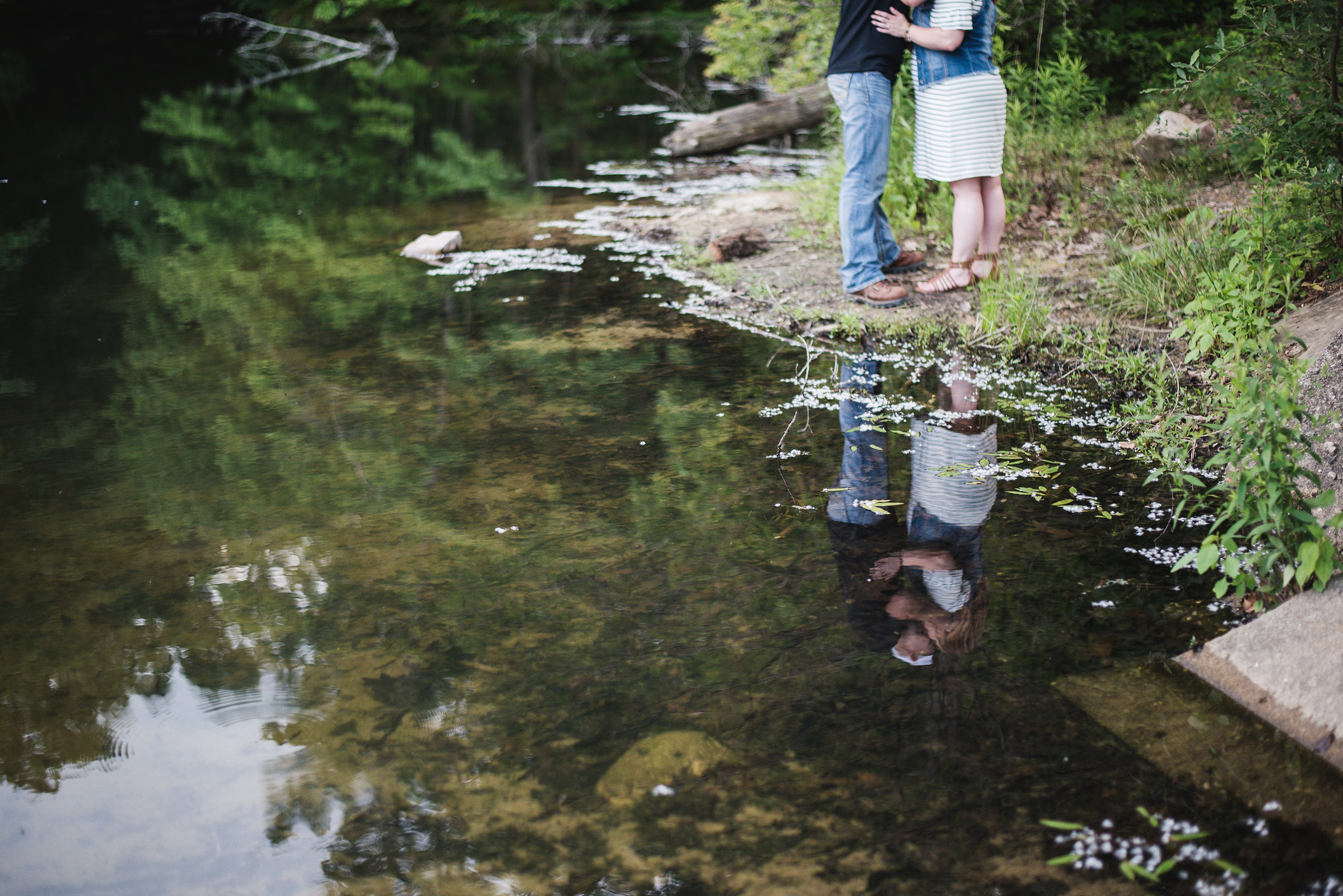 lake reflection couple kissing alley park engagement