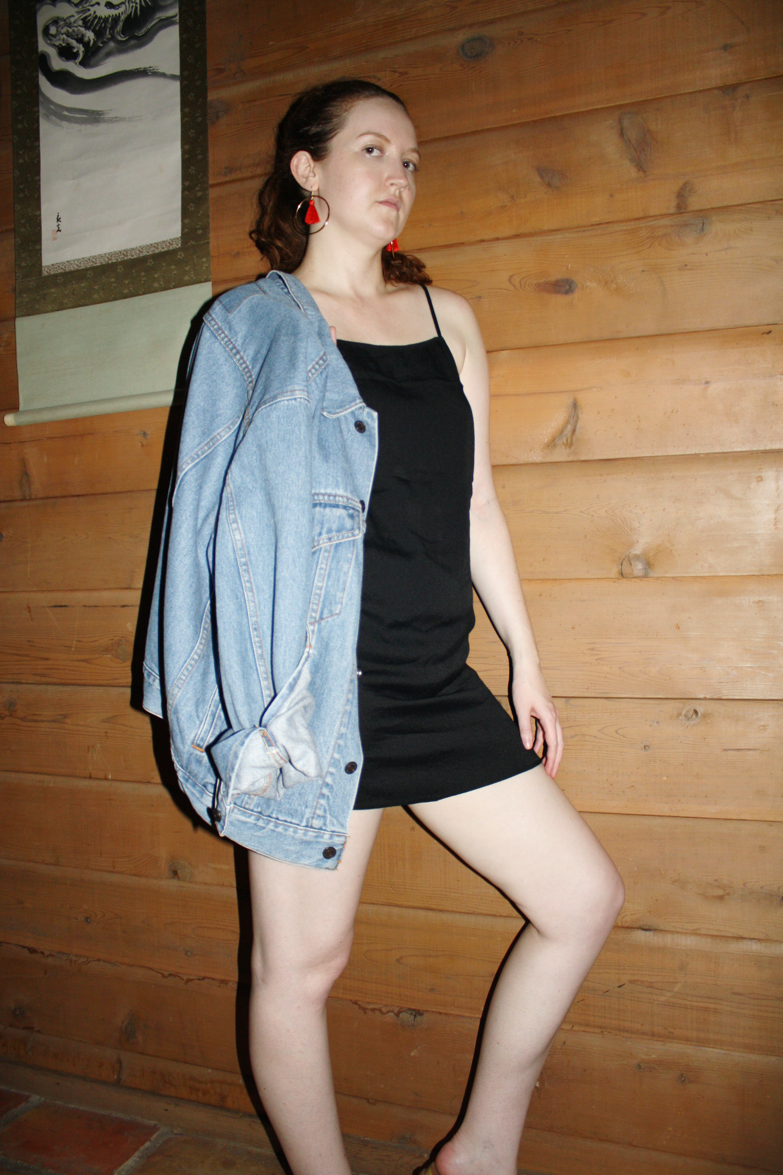 What do I wear to rock my 30s anything you want Vintage Levi's denim jacket Reformation black slip dress J Crew red tassel earrings