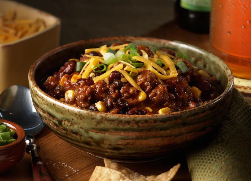 1 lb Johnsonville Italian Ground Mild, Sweet or Hot Italian Sausage 1 lb ground beef 1 medium onion, chopped 3 celery ribs, chopped 3 garlic cloves, minced 3 cans (14.5oz each) diced tomatoes with green pepper and onions 2 cans (16oz each) kidney beans, rinsed and drained 1 can (14.5oz) beef broth 1 can (6oz) tomato paste 2 Tbsp brown sugar 1 Tbsp chili powder 2 tsp ground cumin 1 Tbsp Worchestershire sauce ½ tsp crushed red pepper flakes Shredded cheddar cheese optional In a large saucepan, cook sausage and ground beef over medium heat until no longer pink; drain. Add the onions, celery and garlic. Cook and stir for 5 minutes or until tender. Stir in the tomatoes, beans, broth, tomato paste, brown sugar, chili powder, Worchestershire sauce, cumin and red pepper flakes. Bring to a boil. Reduce heat; cover and simmer for 20 minutes. Sprinkle with cheese.