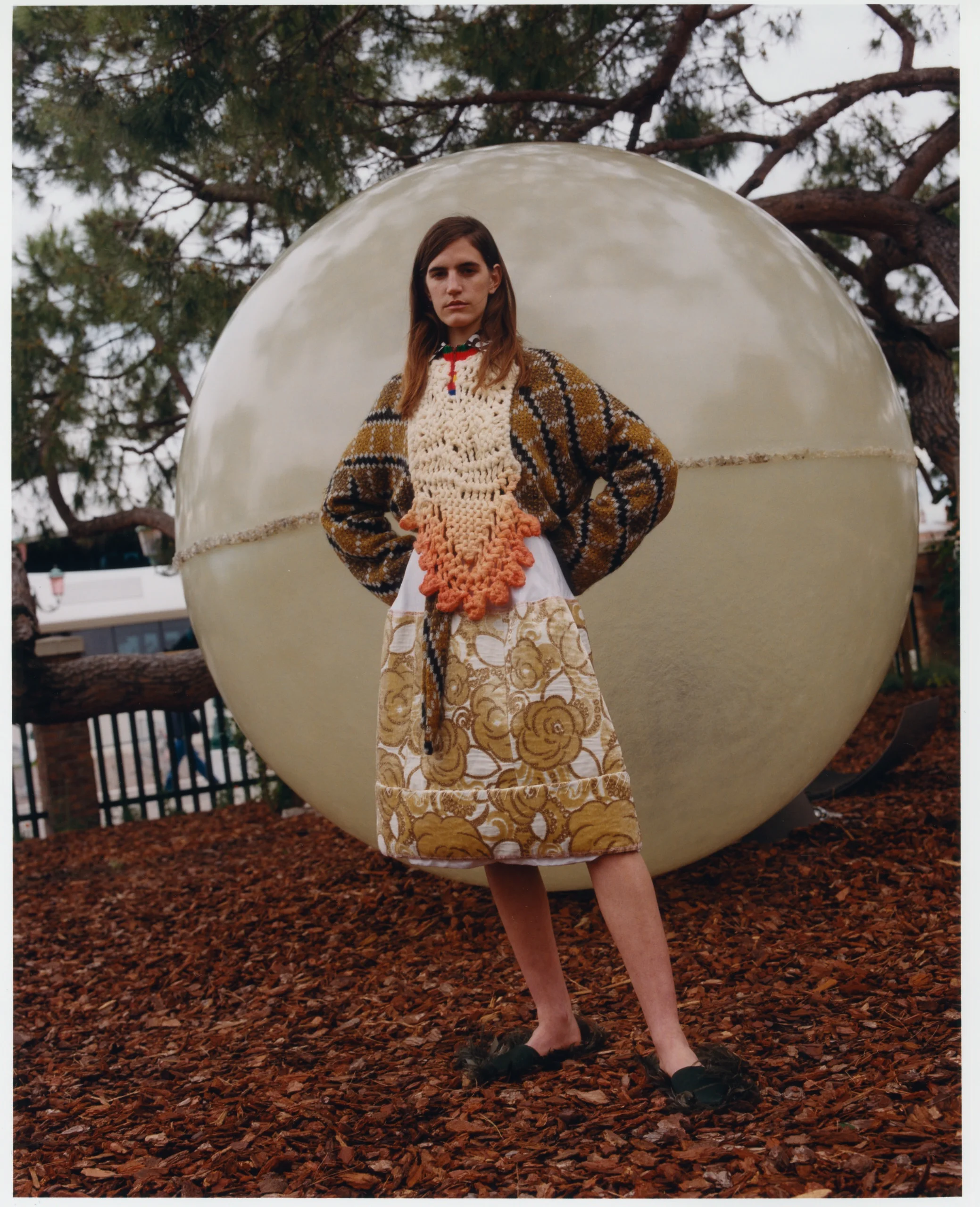 Sweater by Loewe. Shirt by Katharine Hamnett. Bib by Congregation. Skirt by Marni. ‘The Sphere 3D Spectrum’, by Clifton Mahangoe. Photography: Jack Symes. Fashion: Marianthi Hatzikidi