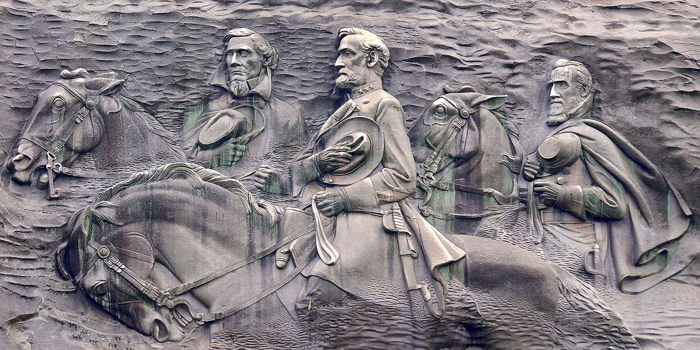 Robert E. Lee, Jefferson Davis and Stonewall Jackson are carved 400 feet above the ground on the side of Stone Mountain, in Georgia. The carving is protected by law, but Democratic candidate for governor, Stacey Abrams, called for the removal. (Wikimedia Commons)