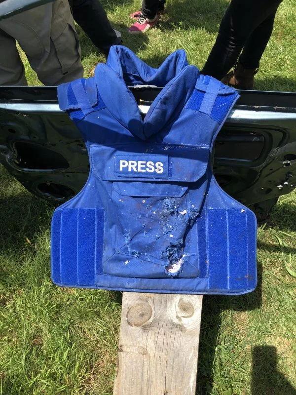 A press jacket with a bulletproof vest that has been hit by gunfire. (Rebecca Gibian/RealClearLife)