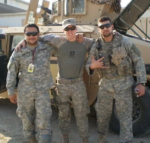 Wisam al-Baidhani and Peter Farley stand alongside another interpreter in Baghdad, Iraq, in 2009.Credit: Courtesy of Peter Farley