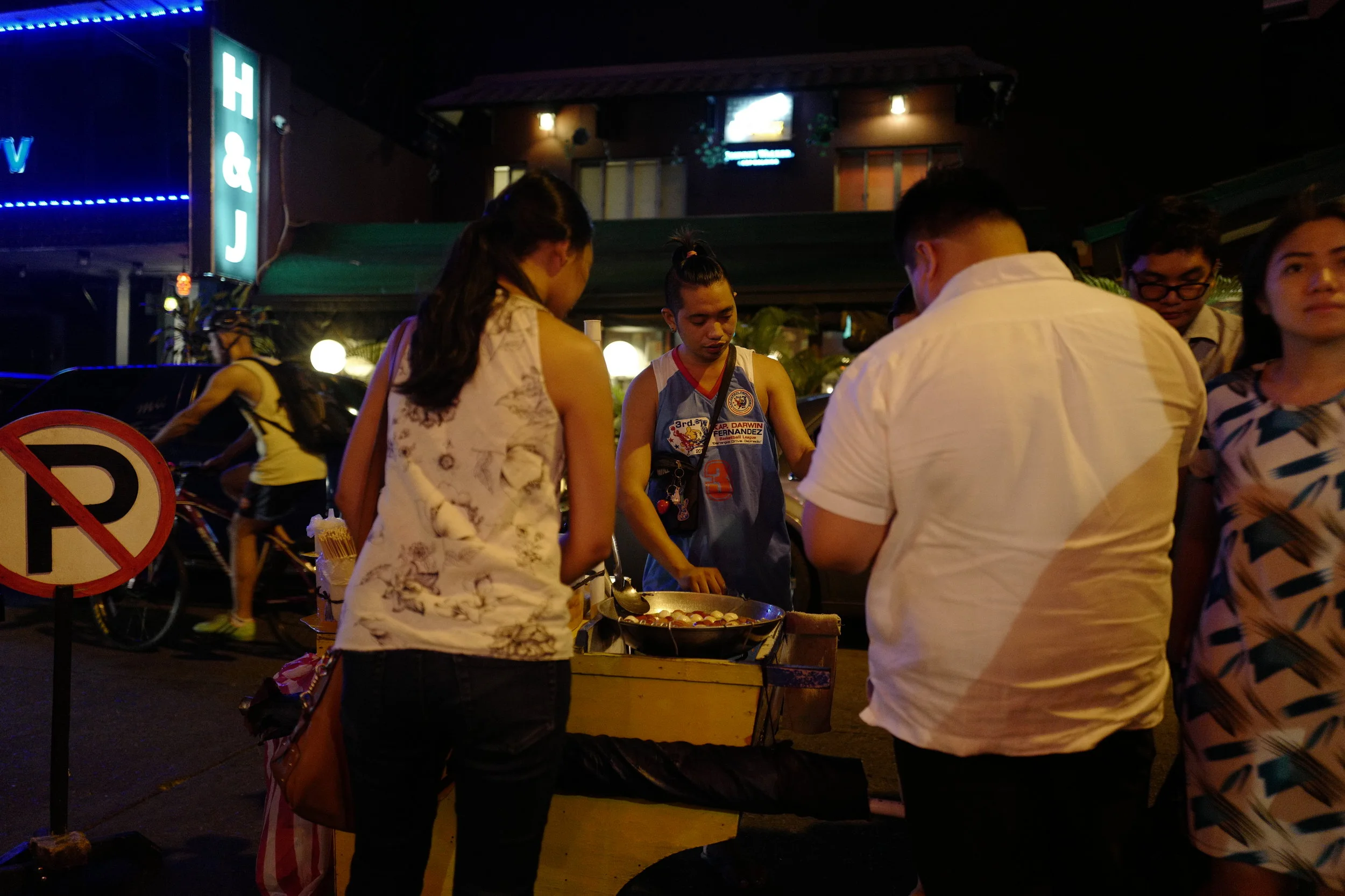  Little street food carts come rolling by every so often, hoping that the drunchies will get the best of ya. This guy was selling squid balls and sausages. 