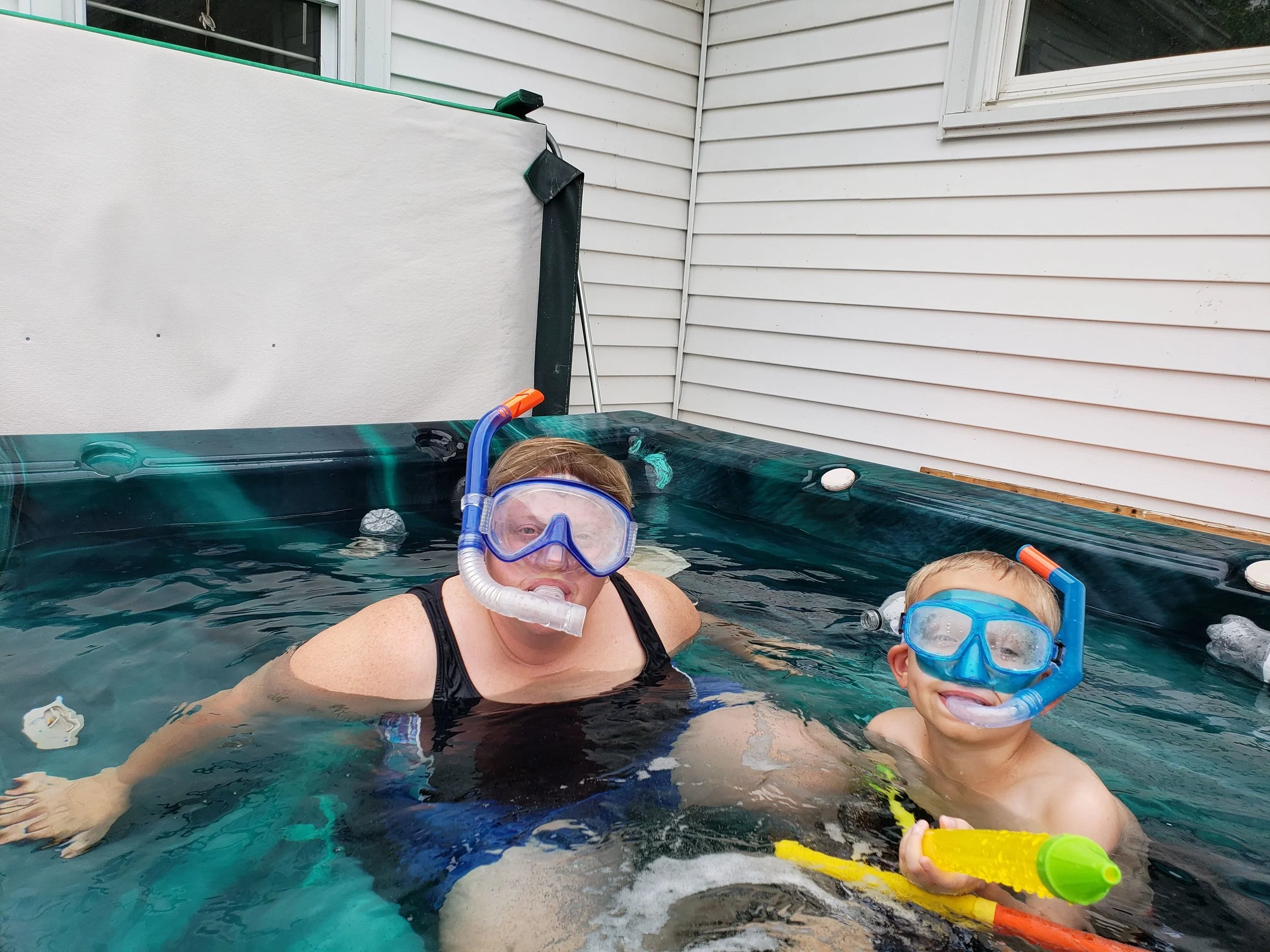 Susan and our nephew Evan snorkeling in the hot tub during Aunt Camp.