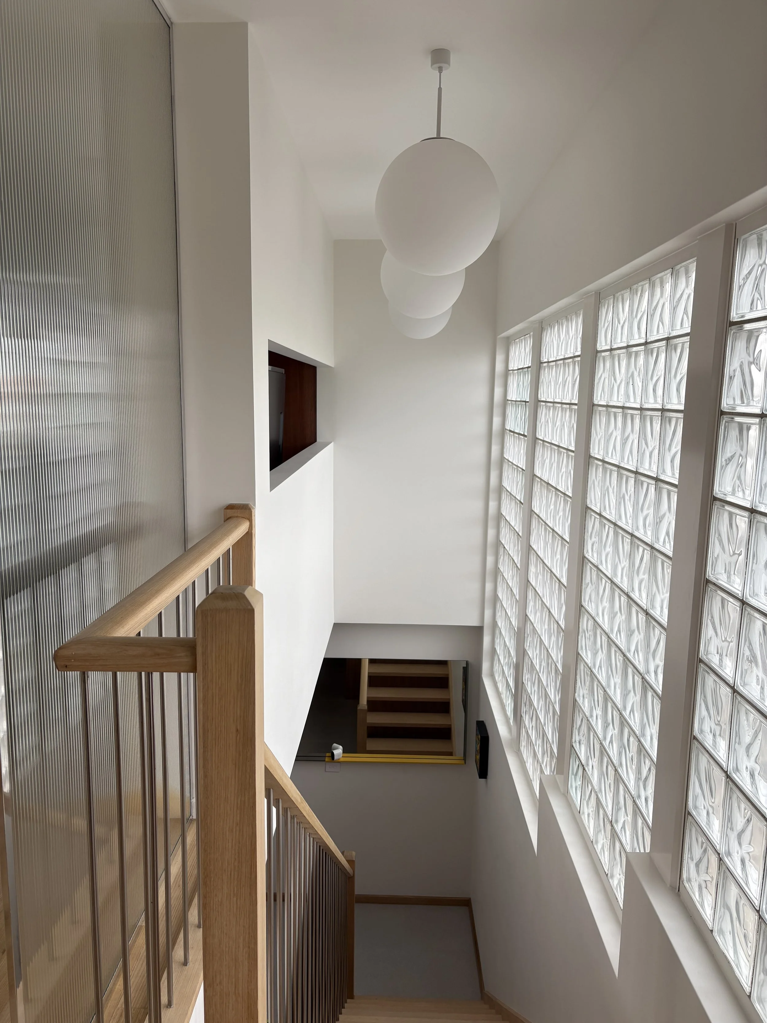 Luxton Architecture — interior staircase design with glass block windows, timber railing and pendant lighting, Northcote Melbourne residential project
