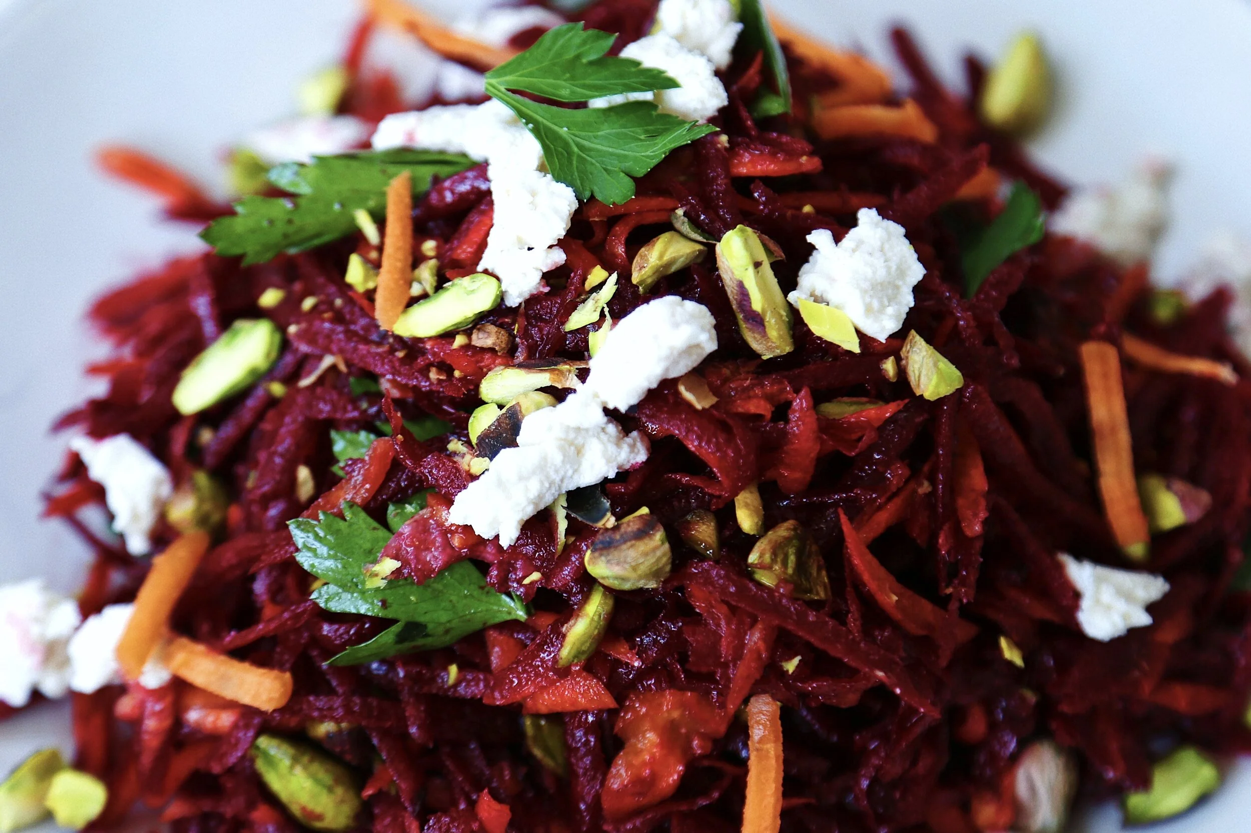 Your new favorite Mediterranean-inspired loaded summer slaw with beets, carrots, pistachio, feta and more!