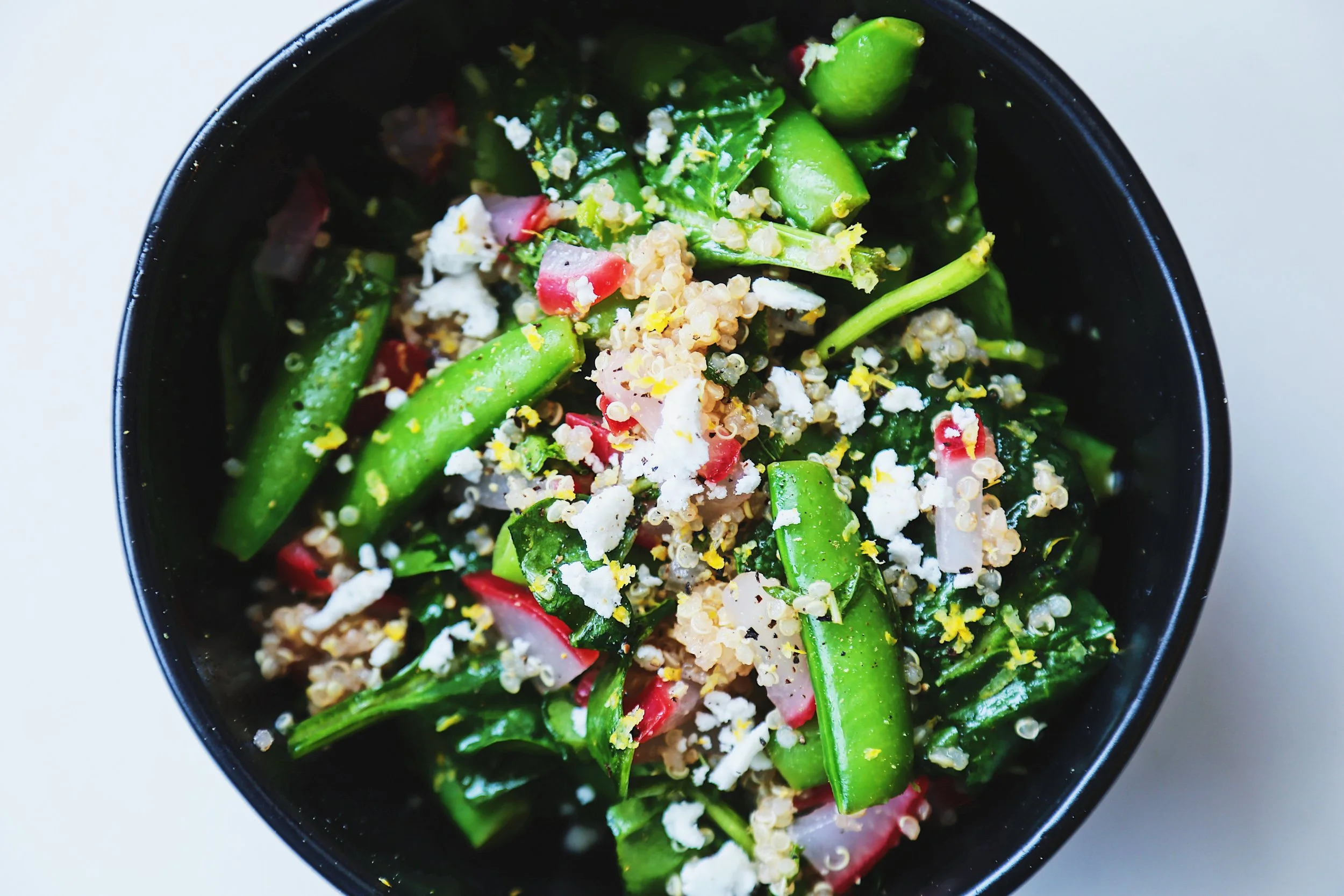 Confetti bowl with snap peas, radish, spinach, quinoa tossed in a minty citrus dressing