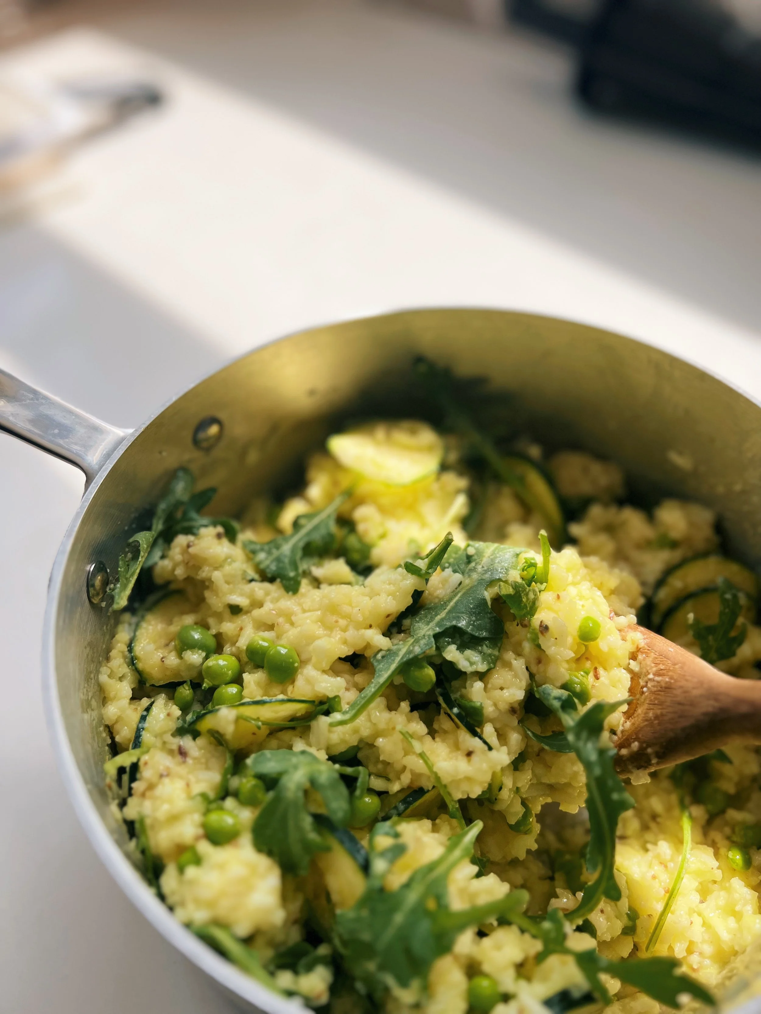 Coconut turmeric spiced rice with shaved zucchini, spring peas and arugula