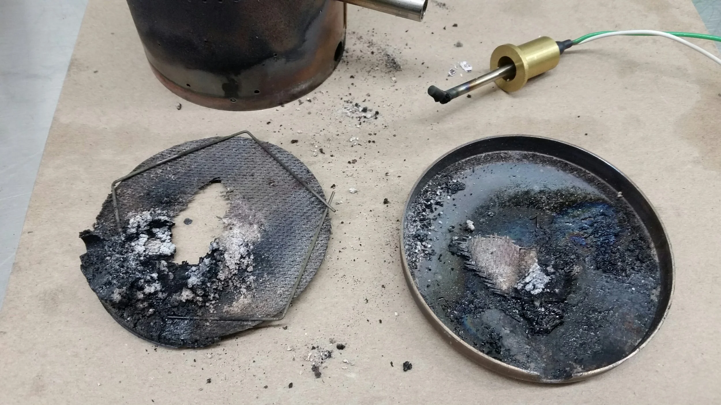 Many hours of use for this diesel forced air unit show burned carbon residue from the fuel. Note the burned metal temperature sensor.