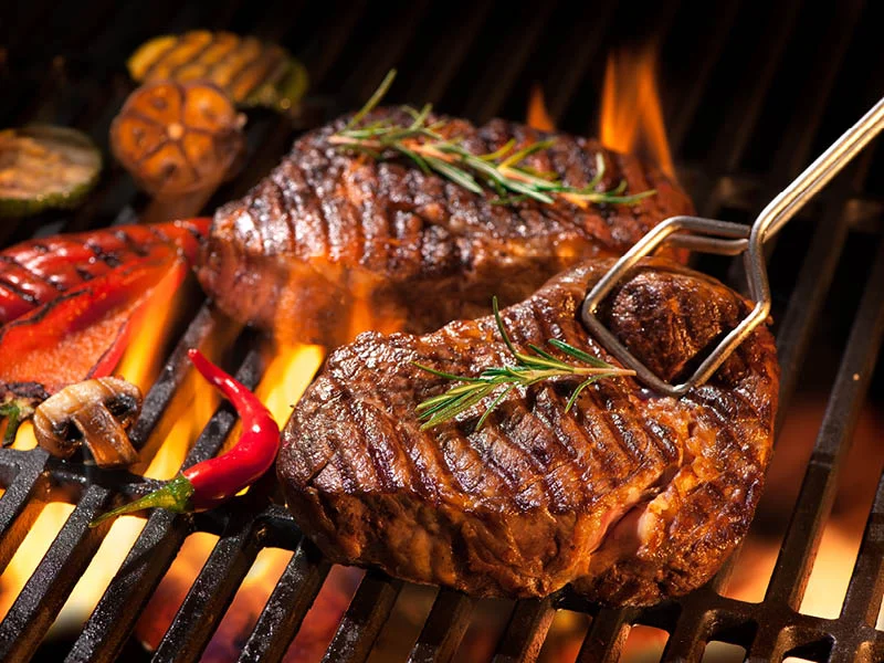 Steaks on a fiery barbeque
