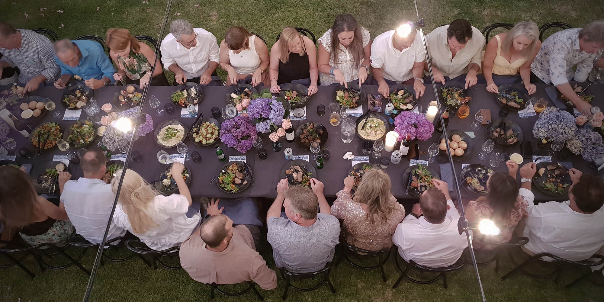 Above view of long table guests dining on Samphire Catering sharing platters 