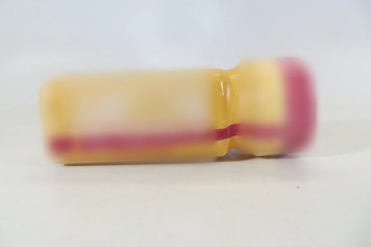 Small yellow bottle of a kratom shot sold as containing 7-hydroxymitragynine, with the label blurred.