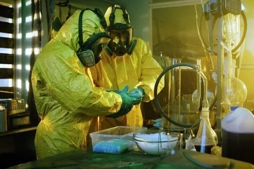 Technicians in hazmat suits performing fentanyl cleanup