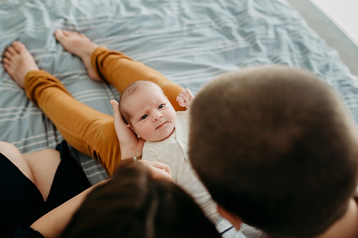 looking between mum and dads head at baby's face
