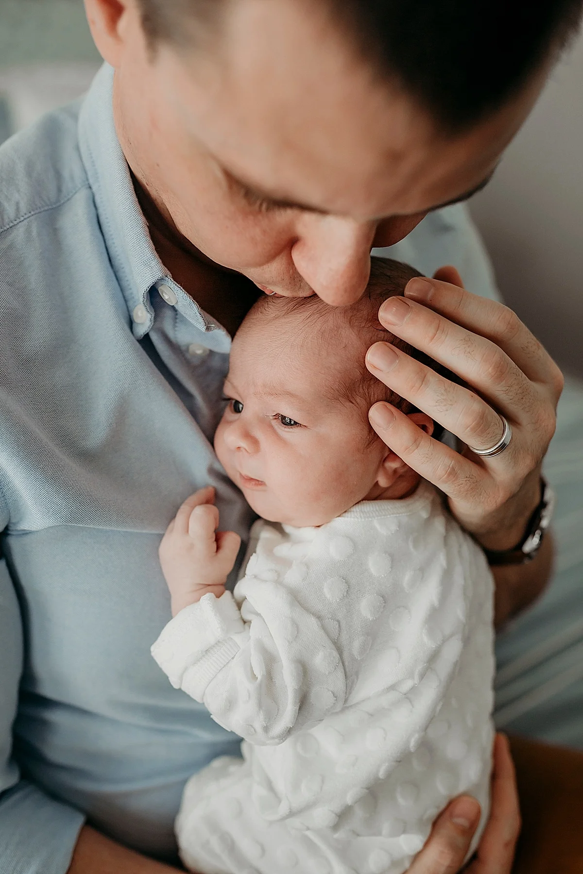 baby girl cuddling with her dad