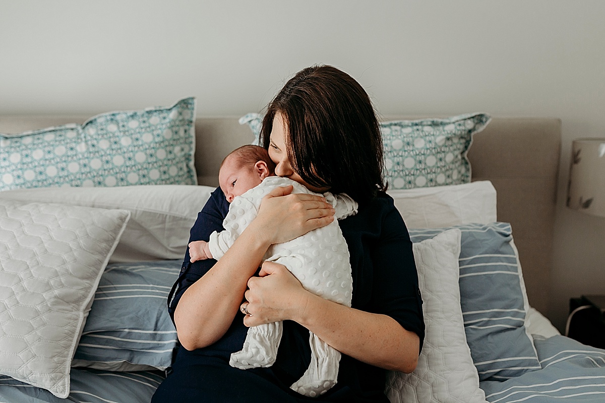 mother nuzzling into baby's neck