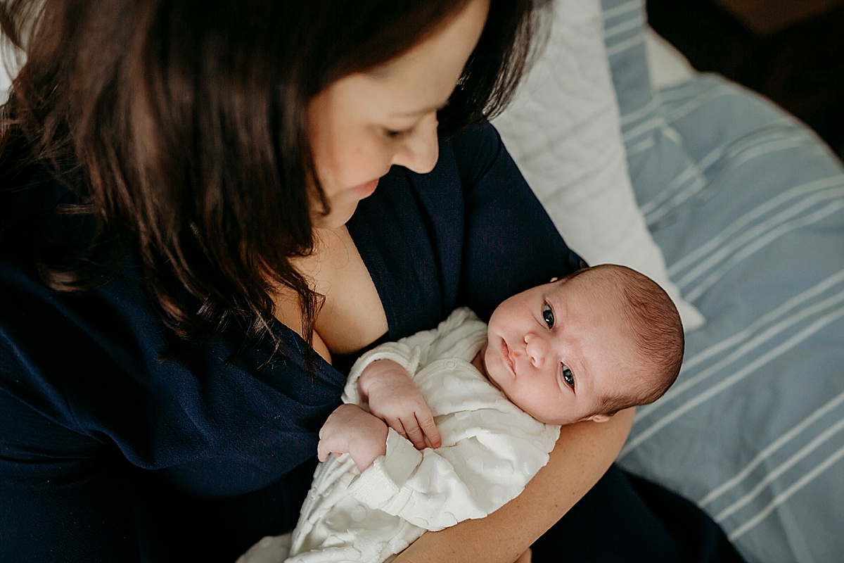 looking down on mother holding baby in her arms