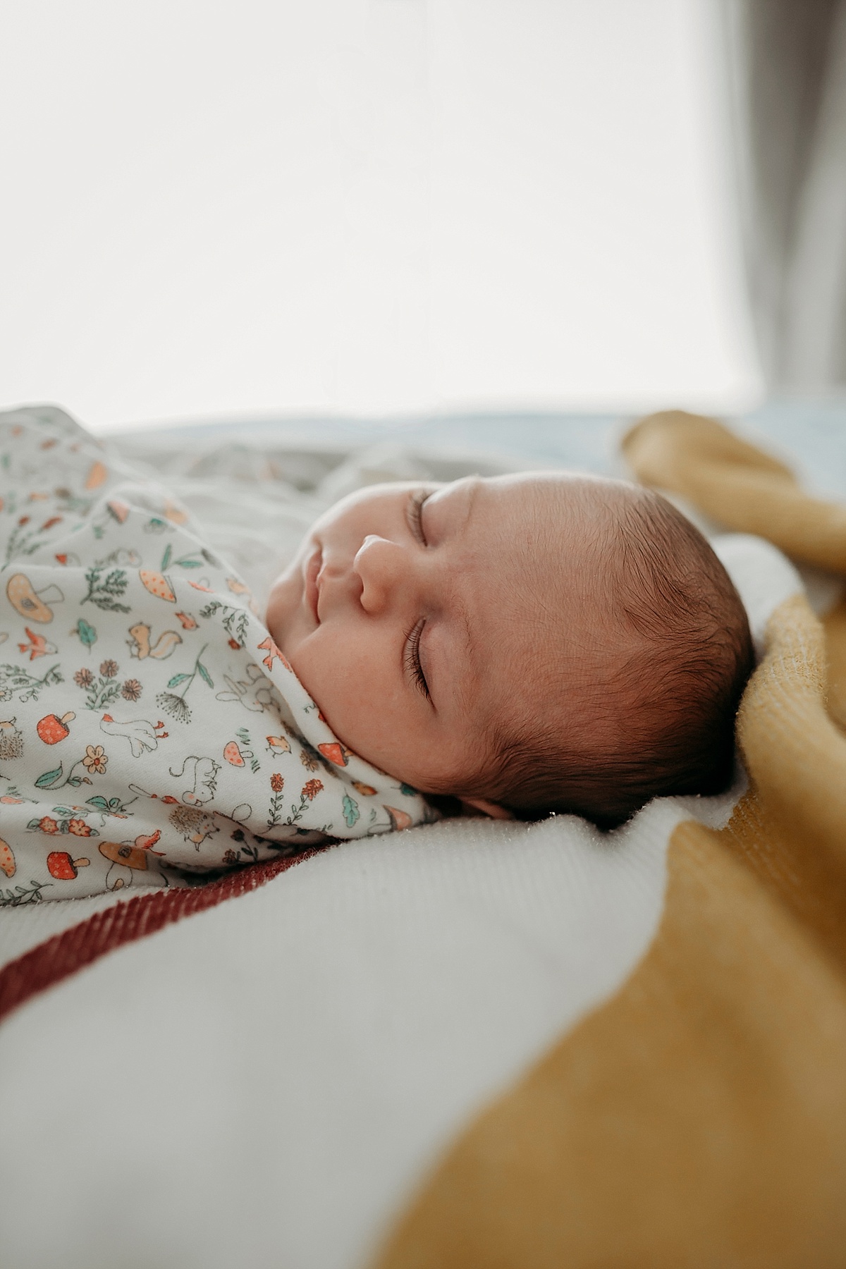 looking along bed at baby asleep