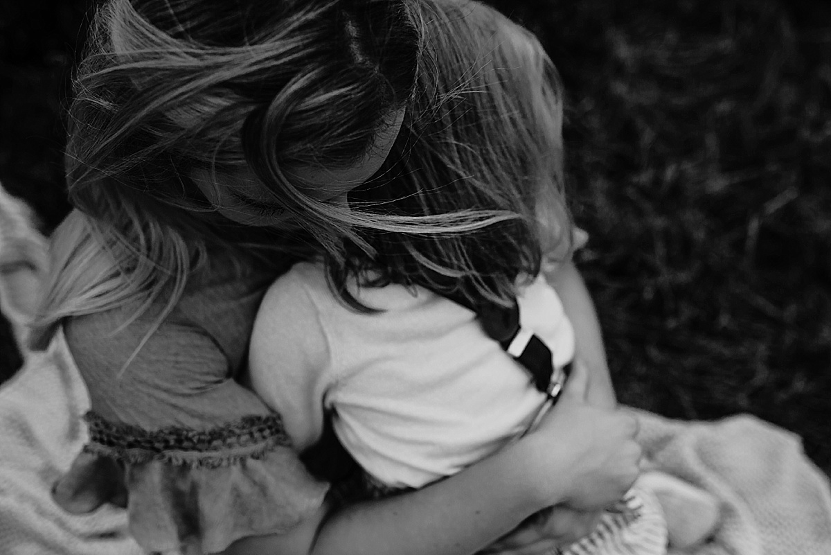Looking down on mother embracing daughter