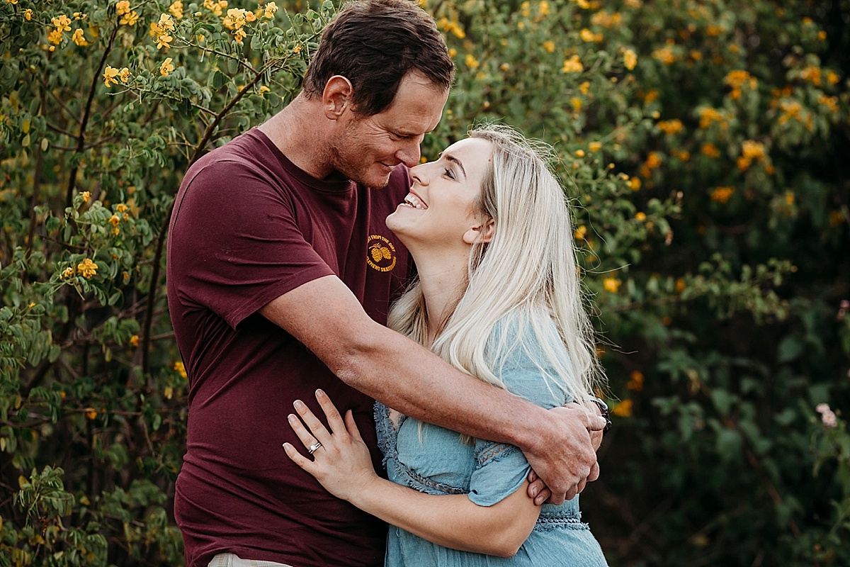Couple hugging looking at each other laughing
