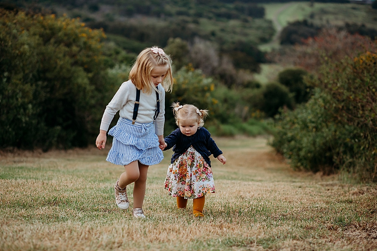 Sisters holding hands walking