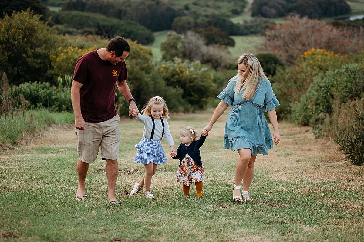 Family all holding hands walking