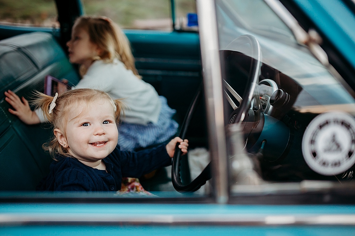 Baby girl pretending to drive