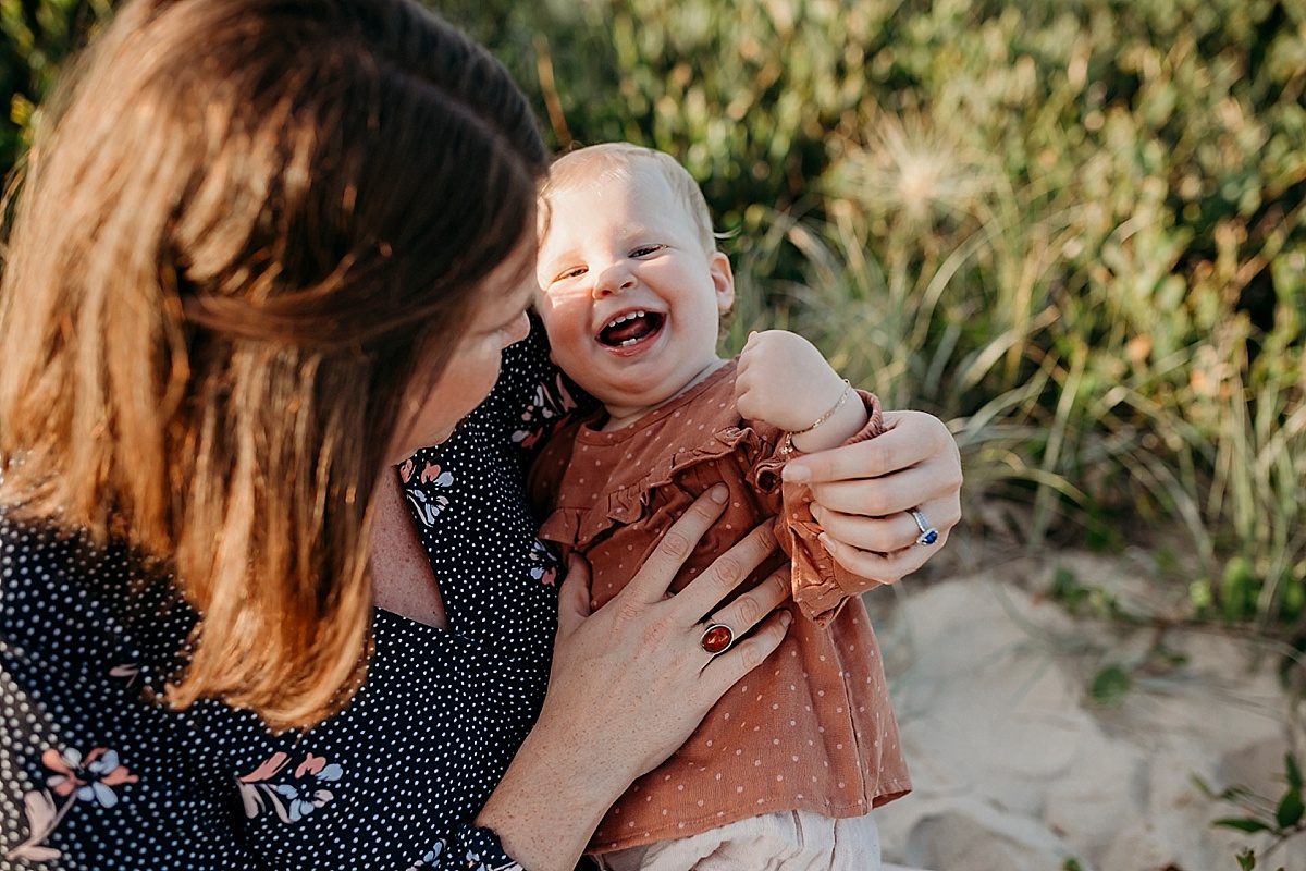 mum tickling baby girls tummy