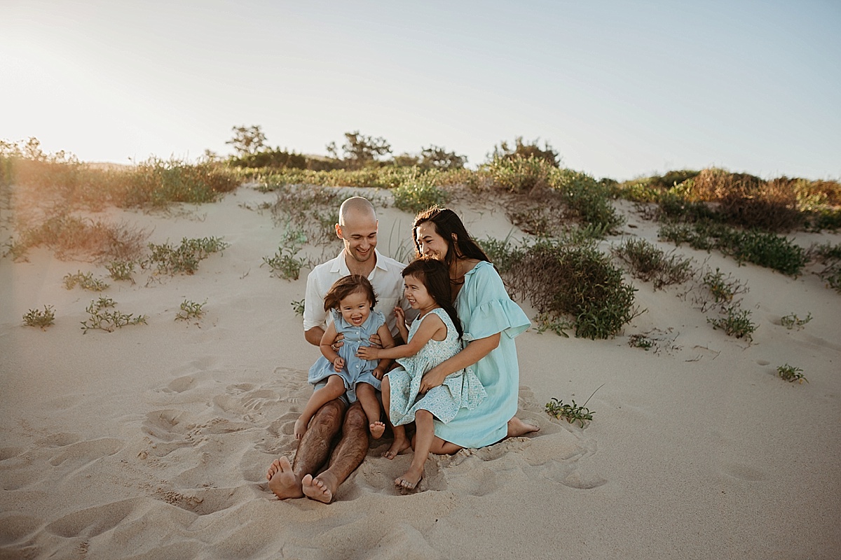 Family on beach at sunset