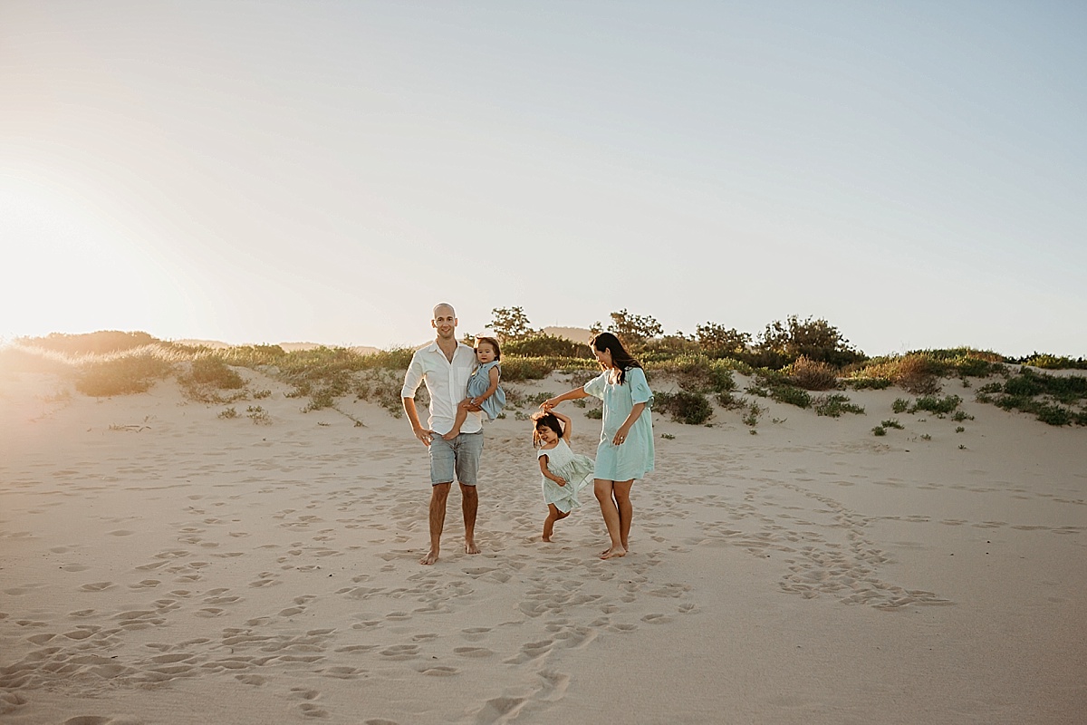 family dancing on the beach in wollongong