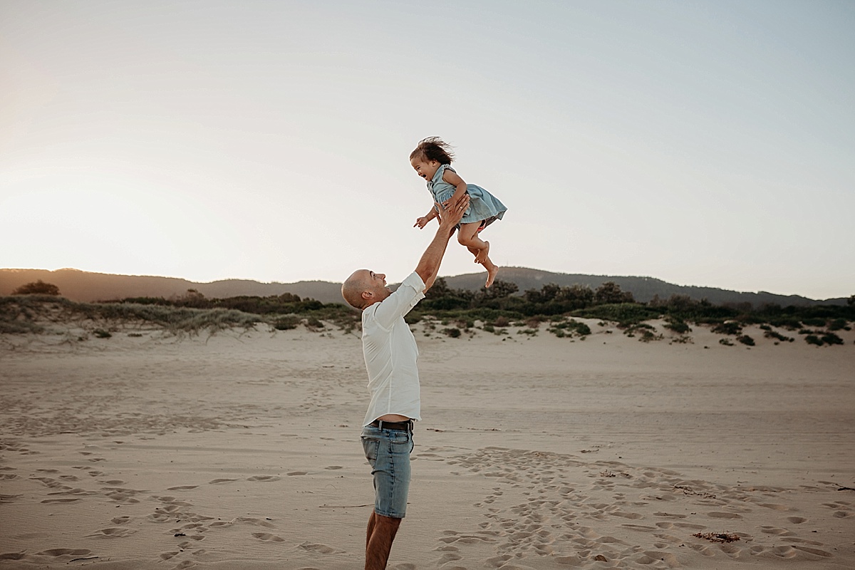 dad throwing daughter in the air
