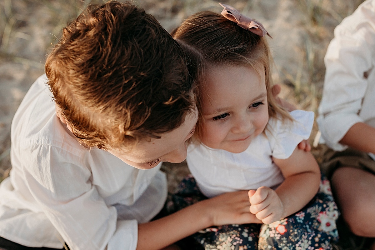 Brother giving little sister a cuddle at photo session