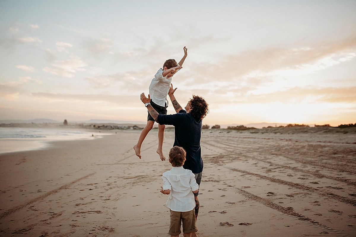 dad tossing boy in air