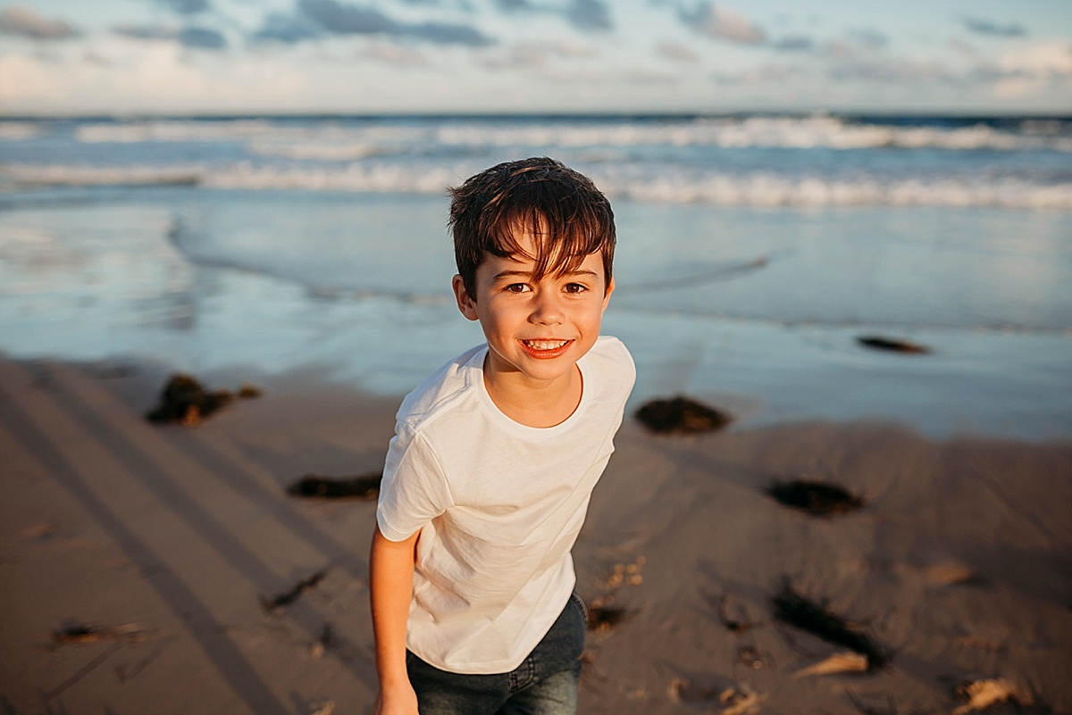 little boy running on beach