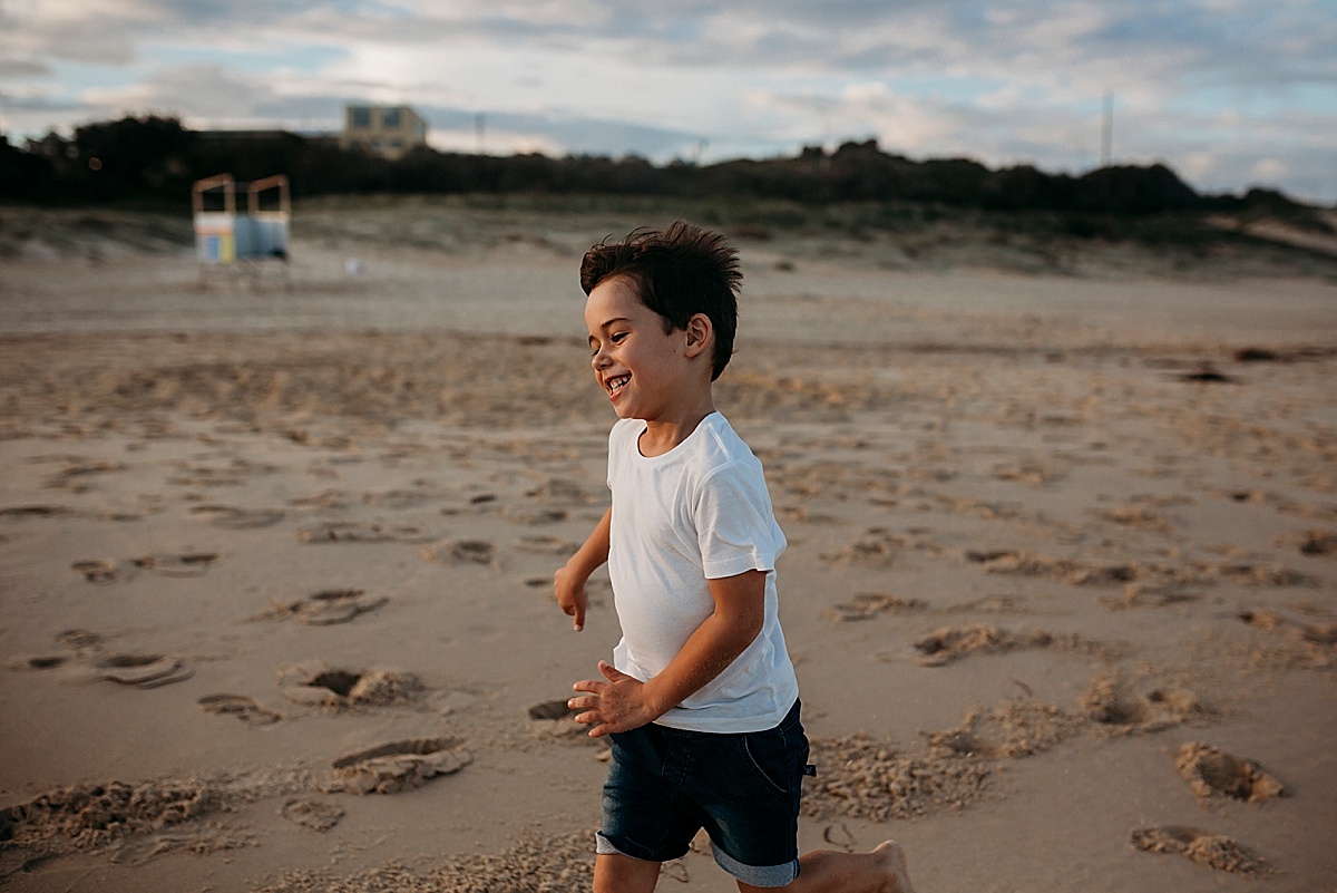 Boy running along port kembla beach