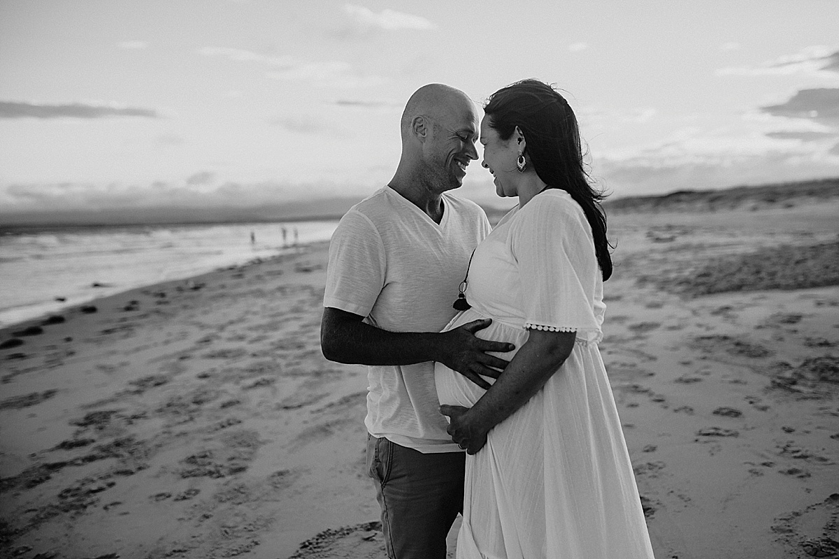 husband gently cuddling pregnant wife at wollongong maternity session 