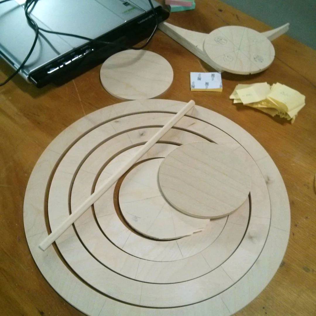 Fig. 3 While we refined the gameplay and visual designs, the CNC Router was hard at work cutting the physical game board and game pieces out of plywood.