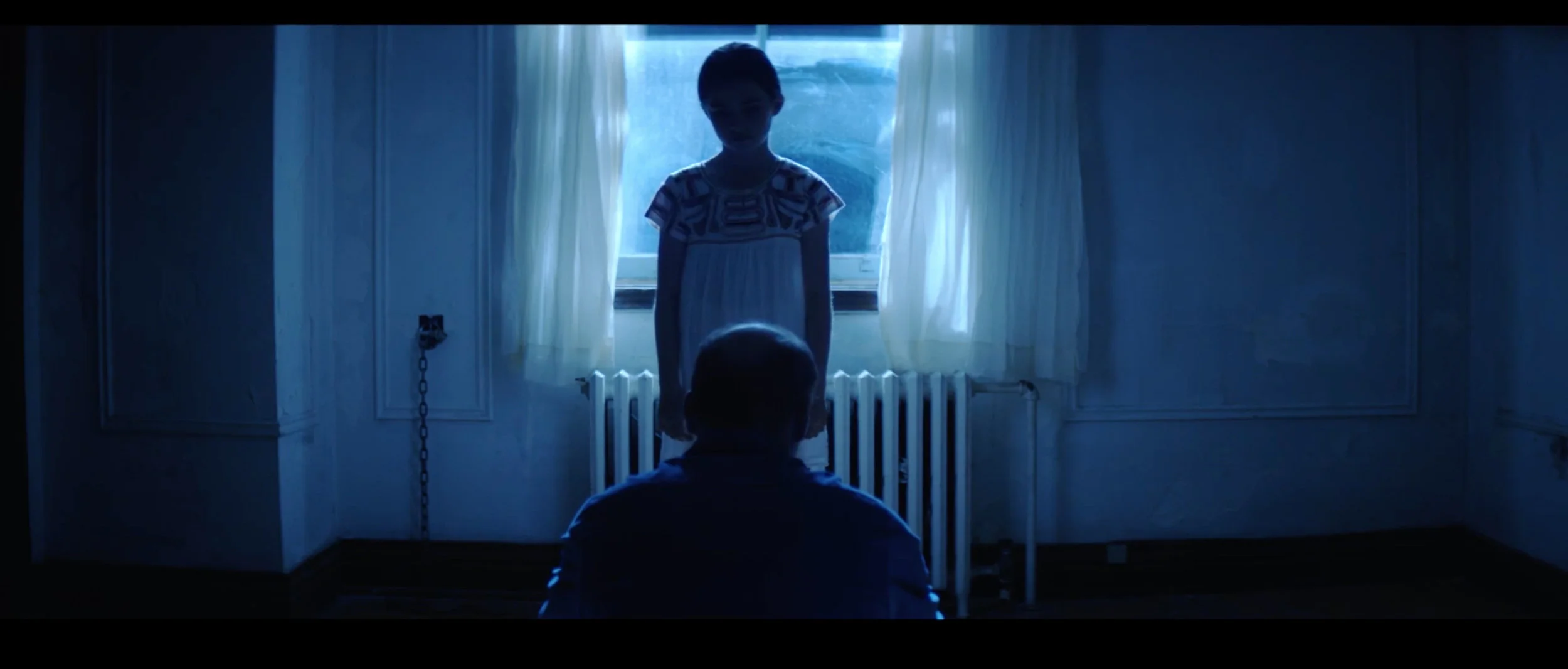A loner experiences apparitions and visits by a young girl chained to a wall in Touched.