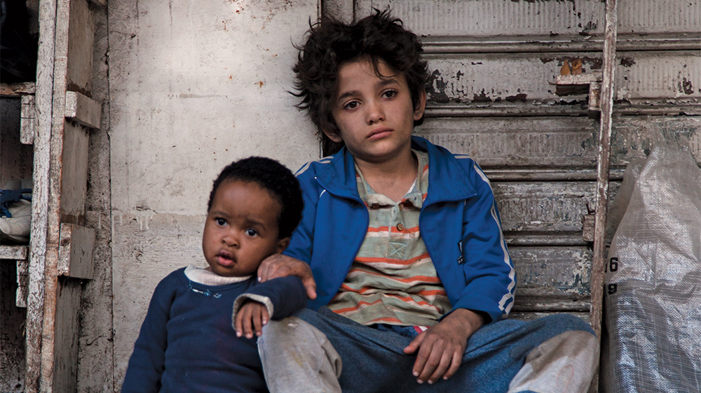 Zain (Zain Al Rafeea) becomes a homeless “guardian” to Yonas (Boluwatife Treasure Bankole)