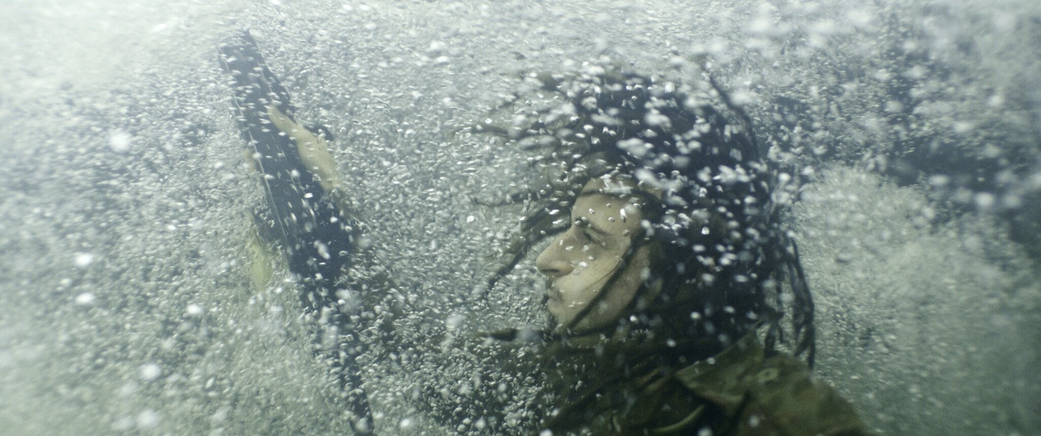 A submerged Bigfoot (Moises Arias) chases ascapees and challengers even underwater.