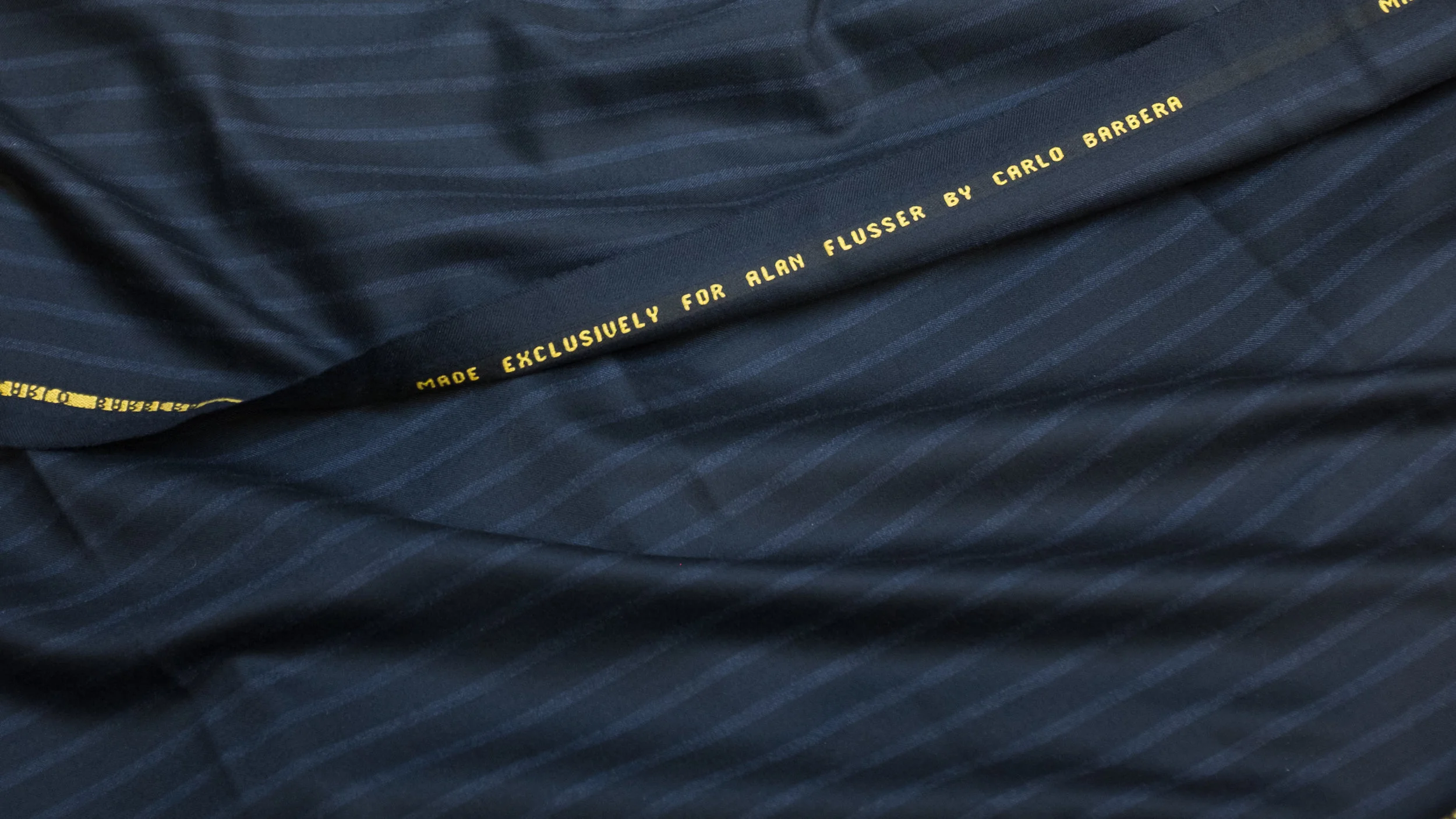 Navy with Mid-Blue Shadow Stripe - Perhaps the most avant garde of Alan’s exclusive cloths, this unusual 9½ oz suiting is at once striking and subtle. Its alternating bands of navy and mid-blue confer the energy, movement, and slimming qualities of bolder stripes with none of the flashiness. Not too stylish for a dignified CEO, not too dull for a confirmed clotheshorse.