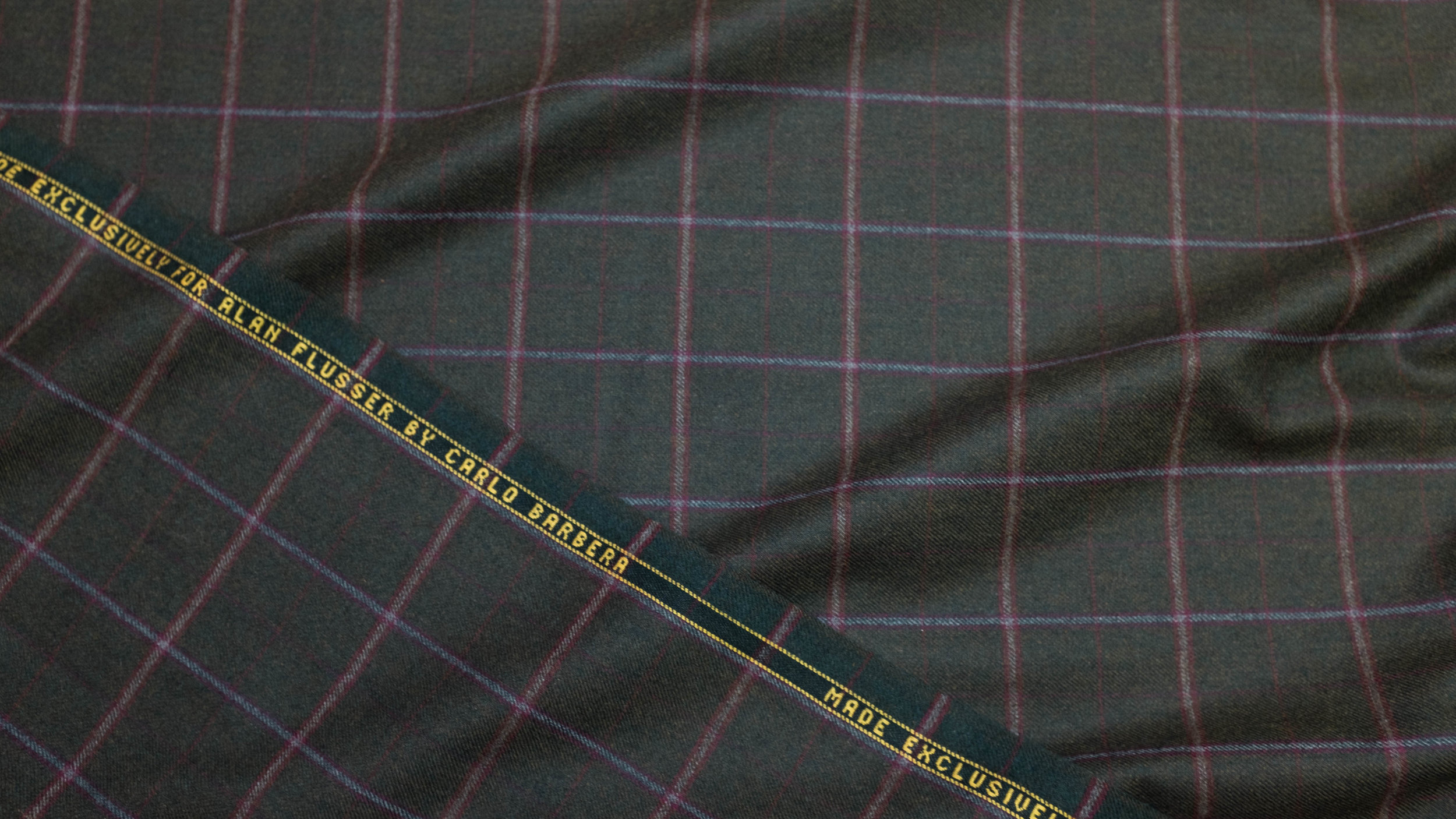 Alan has always believed that sophisticated greens like this one — complementary to most complexions and easy to wear with almost any trouser — are woefully underrepresented in men’s wardrobes. The blue-grey overplaid of this 10 oz wool flannel plays perfectly with either blue jeans or grey flannels, and the pomegranate plaid adds just the right dash of warm contrast without making the cloth too seasonal.